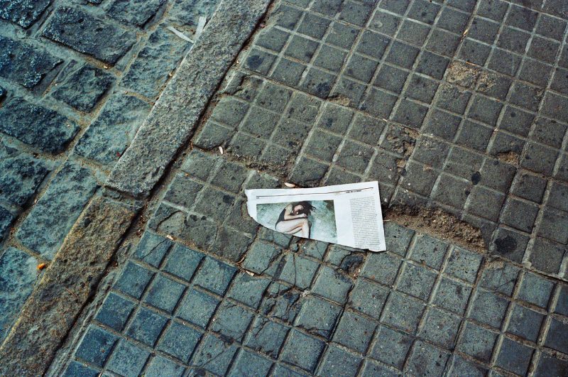 pavement with torn newspaper in El Puerto de Santa Maria, Spain