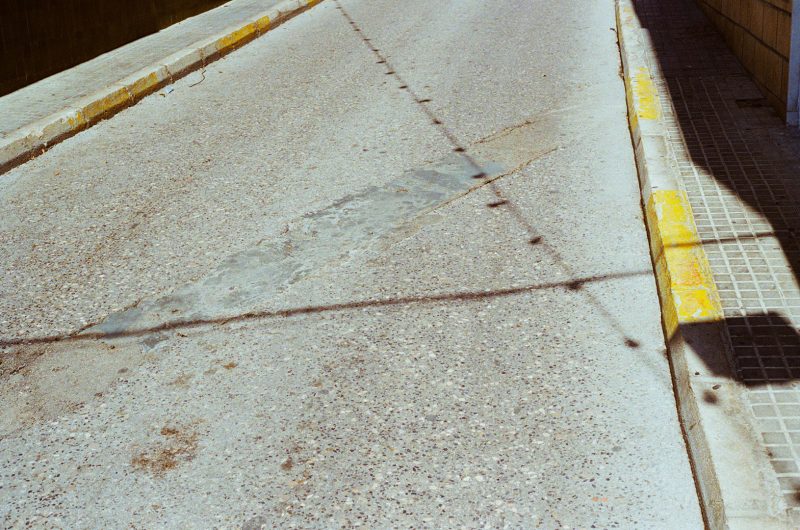 shadows on road in Spain with with measures to prevent parking